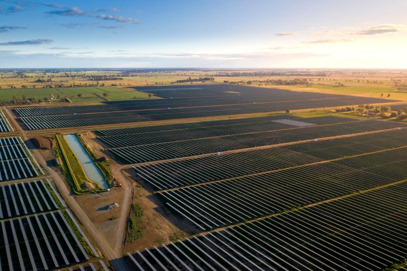 An aerial image of a solar farm at sunrise