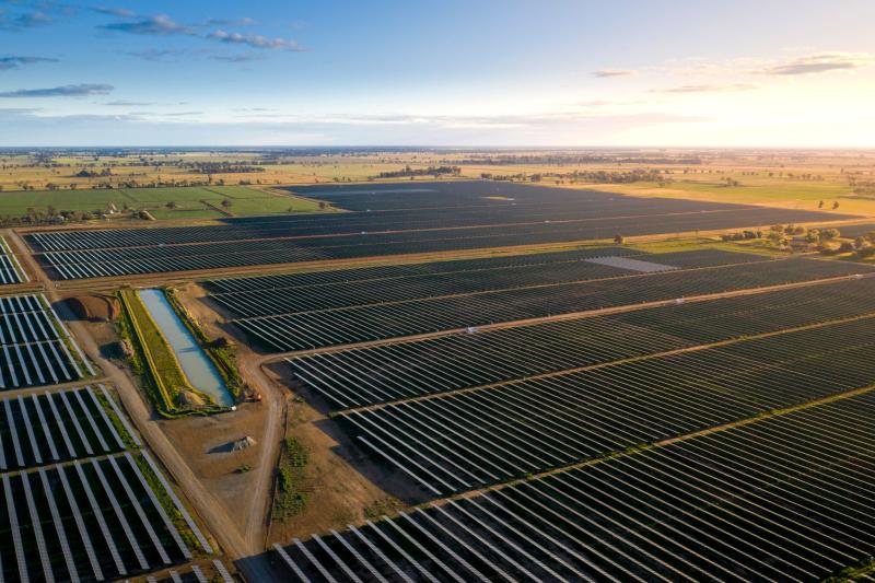 An aerial image of a solar farm at sunrise