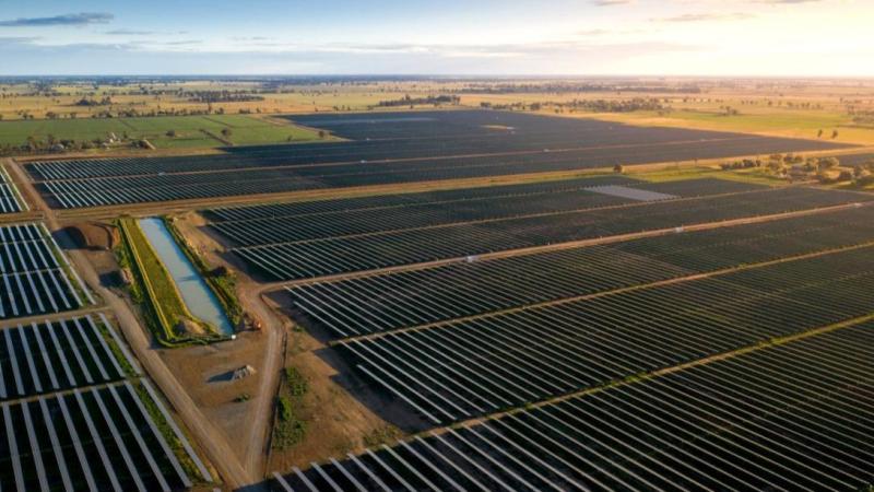 An aerial image of a solar farm at sunrise