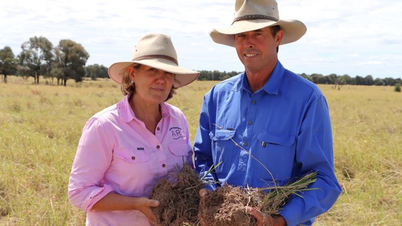 Photograph of Antoinette and Tom holding soil from Goondiwindi, QLD